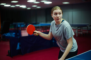 Portrait of a young girl table tennis player with racket playing ping pong