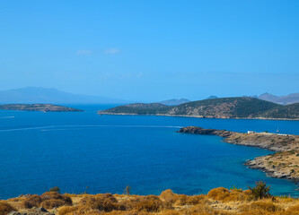 Obraz premium Amazing Seascape from the hill near Bodrum, Turkey. Beautiful tree and srone in front background. Aegean Marine view. Vacation in Turkey