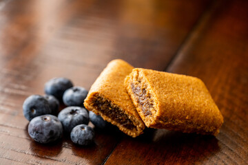 Wooden table food photography fig bars and blue berries