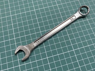 Chrome car key size 14 on green table