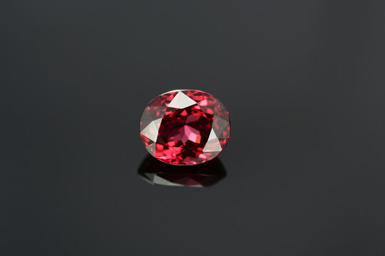 Natural rich cherry red spinel gemstone. Oval faceted, clean stone. Bright juicy color. Highly saturated. Shiny, great luster. High value semiprecious gemstone setting. For making jewelry. Isolated.
