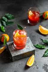A glass of orange cocktail with ice cubes. Summer refreshing cocktail