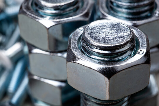 steel nuts, screwed on a bolt closeup