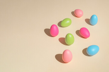 2021 Easter bold and minimal still life composition. Colorful eggs arranged on beige background. Trendy minimal concept.