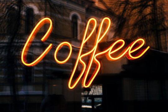 Cafe neon glowing sign with coffee lettering.