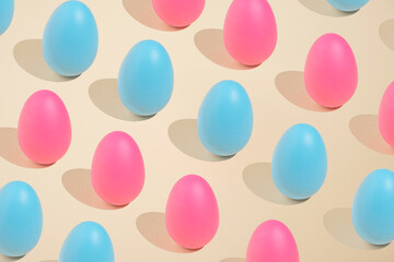 2021 Easter bold and minimal still life composition. Pink and blue eggs arranged on beige background. Trendy minimal concept.