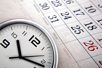 large white clock face with calendar sheets