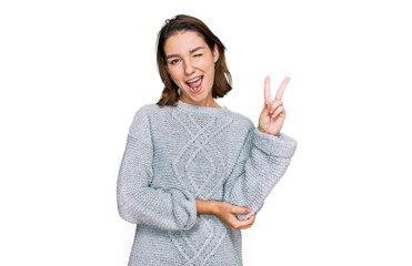 Young caucasian girl wearing casual clothes smiling with happy face winking at the camera doing...