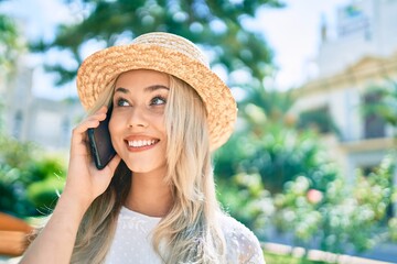 Young caucasian tourist girl smiling happy talking on the smartphone at street of city.