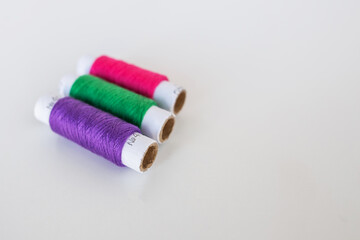 colored threads for sewing on a white background. Copy space.