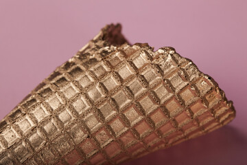 golden cone on pink background