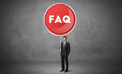 Fototapeta premium Young business person holdig traffic sign