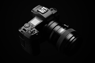 Fototapeta na wymiar professional digital photo camera against black background