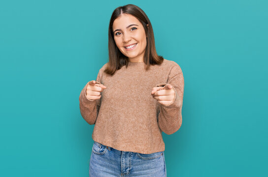 Young beautiful woman wearing casual clothes pointing fingers to camera with happy and funny face. good energy and vibes.