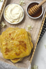 Homemade rghaif or msemen Arab with honey and cream cheese