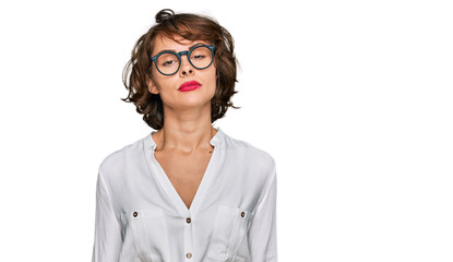 Young hispanic woman wearing business style and glasses relaxed with serious expression on face. simple and natural looking at the camera.