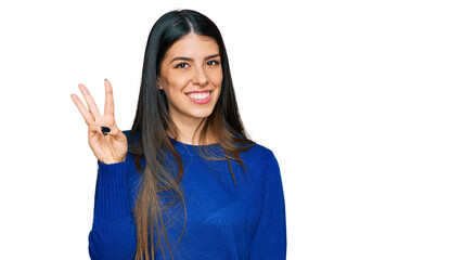 Young hispanic woman wearing casual clothes showing and pointing up with fingers number three while smiling confident and happy.