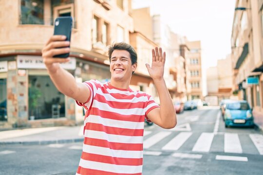 Young caucasian man smiling happy doing video call using smartphone at the city.