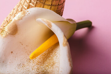a white flower in a golden cone 