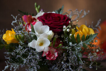 professionally made bouquet of red roses and freesias