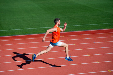 sportsman man in sportswear run fast sprinting on running track, energy