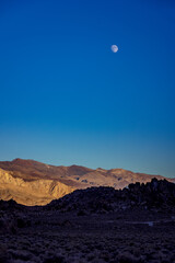 Naklejka premium moon over mountains at sunrise