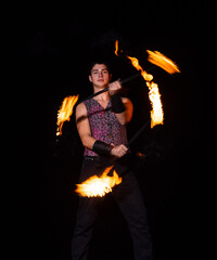 Burning energy. Handsome man juggle flaming batons. Fire juggling. Fire energy. Energetic twirling....