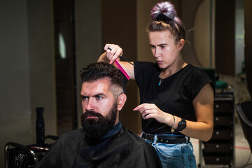 Make your choice. male barber care. bearded man at hairdresser chair in salon. beauty and fashion. hair and beard styling. brutal guy with barbershop professional master use electric shaver. hipster