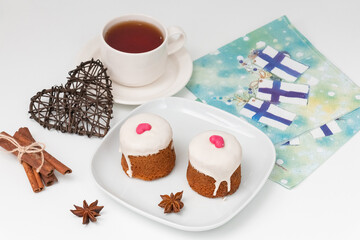 Finnish pastries on a white plate with a cup of tea, cupcakes.