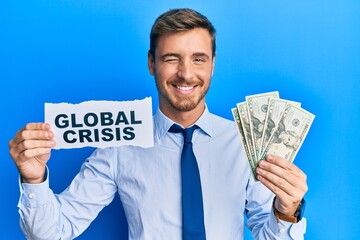 Handsome caucasian business man holding dollars on global crisis winking looking at the camera with...
