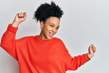 Young african american girl wearing casual clothes dancing happy and cheerful, smiling moving casual and confident listening to music