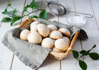 Sugar homemade cookies in a basket on a white table