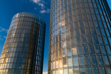 Fototapeta premium Urban architecture. Steel and glass facade of skyscrapers. Stormy sky.