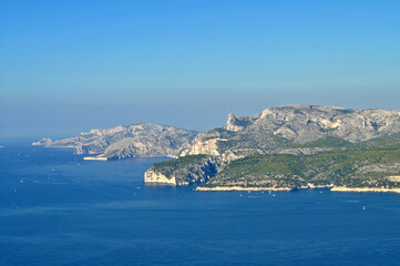 Fototapeta premium Views of the blue sea, green shores and gray rocks in summer in France.