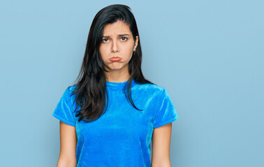 Fototapeta premium Young hispanic woman wearing casual clothes depressed and worry for distress, crying angry and afraid. sad expression.