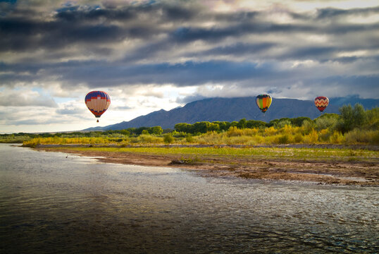 balloons soaring about Sandia Mountains and Rio Grande River during Albuquerque Balloon Fiesta  
