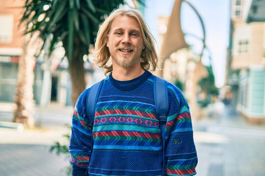 Young scandinavian student man smiling happy standing at the city.