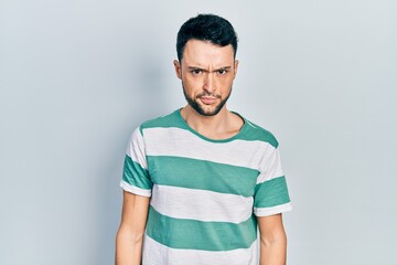 Fototapeta premium Young hispanic man wearing casual clothes skeptic and nervous, frowning upset because of problem. negative person.