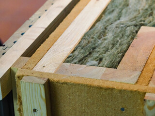 mineral insulation in the wooden wall of the house frame construction