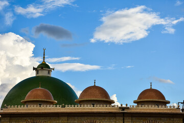 Beautiful cotton clouds behind mosque dome