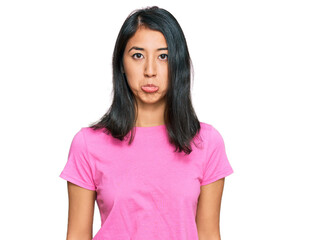 Fototapeta premium Beautiful asian young woman wearing casual pink t shirt depressed and worry for distress, crying angry and afraid. sad expression.