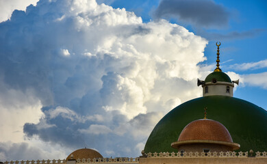 Beautiful cotton clouds behind mosque dome