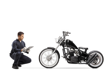 Obraz na płótnie Canvas Bike repairman checking a chopper motorbike