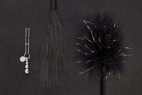 Kinky sex toys, whip, tickler and nipple clamps.