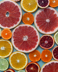 Modern background from sliced citrus fruits. Orange, grapefruit, lime, tangerine, lemon. Organic SPA cosmetics with orange oil and vitamin C.