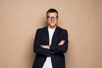 Portrait of young businessman isolated over beige background