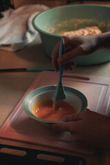 The woman is making pastry in the kitchen