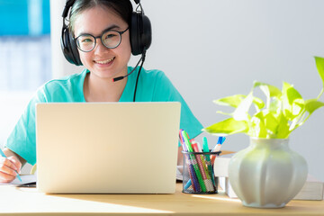 Asian young woman portrait student with glasses headphones happy study smile looking up online class college learning internet education, Teenage girl work distance on a laptop computer from home