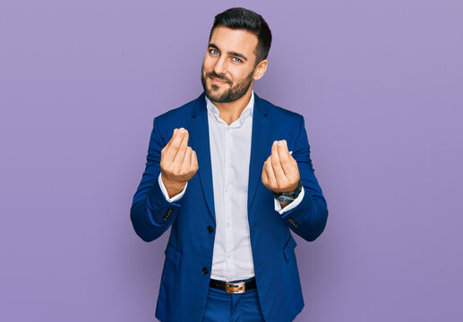 Young Hispanic Man Wearing Business Jacket Doing Money Gesture With Hands, Asking For Salary Payment, Millionaire Business