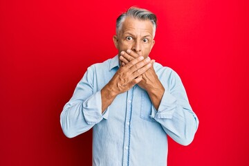 Middle age grey-haired man wearing casual clothes shocked covering mouth with hands for mistake. secret concept.